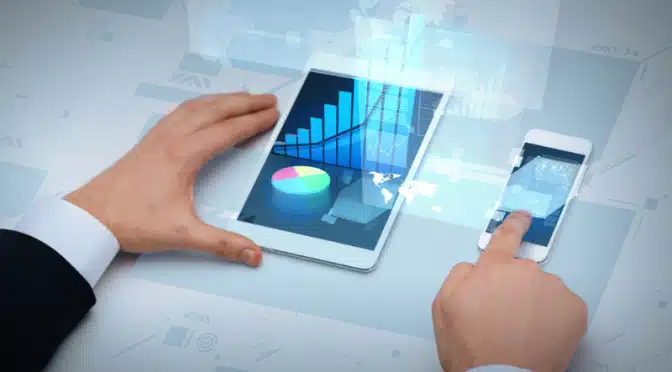cropped image of man working on smart phone and tablet